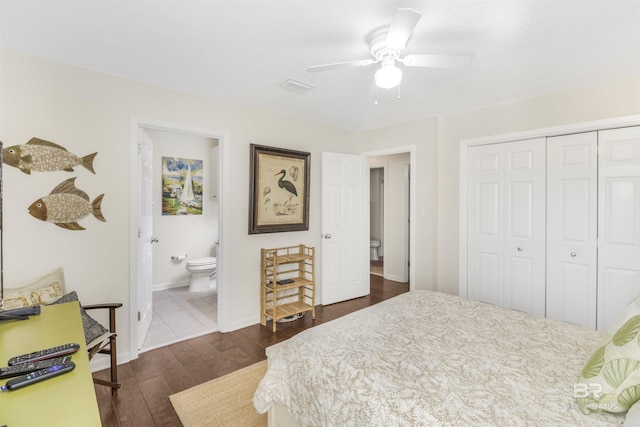 bedroom featuring visible vents, baseboards, a closet, dark wood-style floors, and ensuite bath