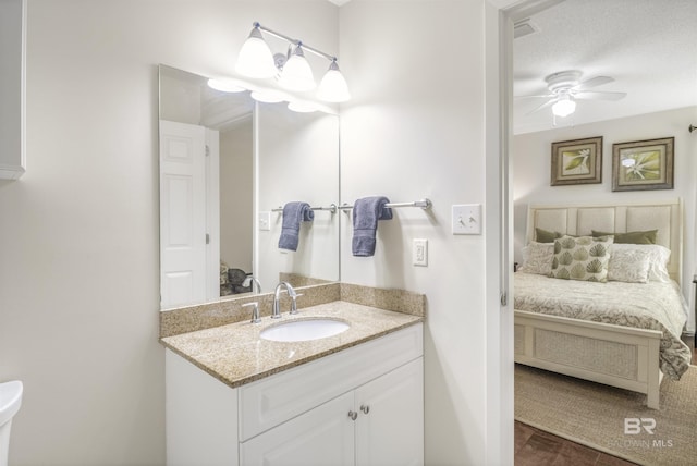 ensuite bathroom featuring visible vents, a ceiling fan, toilet, ensuite bathroom, and vanity