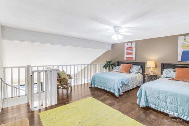 bedroom with vaulted ceiling, ceiling fan, a textured ceiling, and wood finished floors