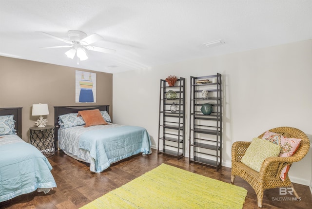 bedroom with wood finished floors, a ceiling fan, and baseboards