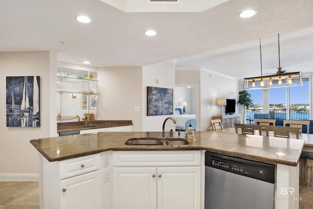 kitchen featuring stainless steel dishwasher, a sink, white cabinetry, and recessed lighting