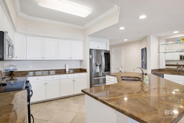 kitchen featuring stainless steel appliances, white cabinetry, and a sink