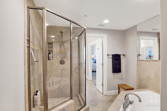 full bathroom featuring a jetted tub, a shower stall, visible vents, and baseboards