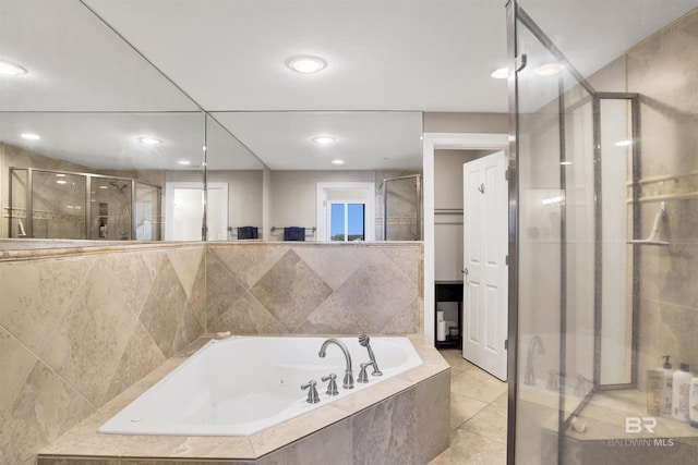 bathroom with a jetted tub, tile patterned flooring, a shower stall, and recessed lighting