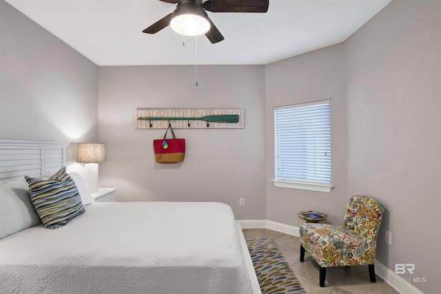 bedroom featuring a ceiling fan and baseboards