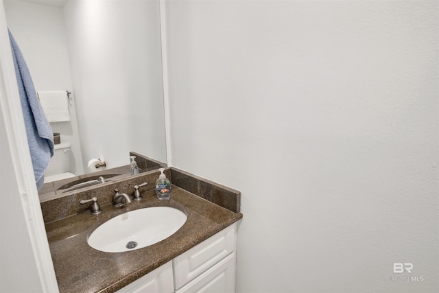 bathroom featuring toilet and vanity