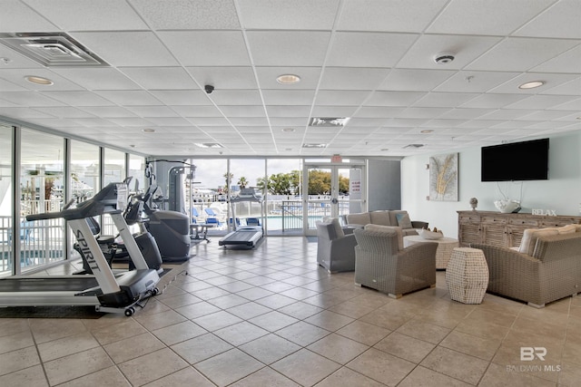 interior space with a wealth of natural light, expansive windows, tile patterned flooring, and visible vents