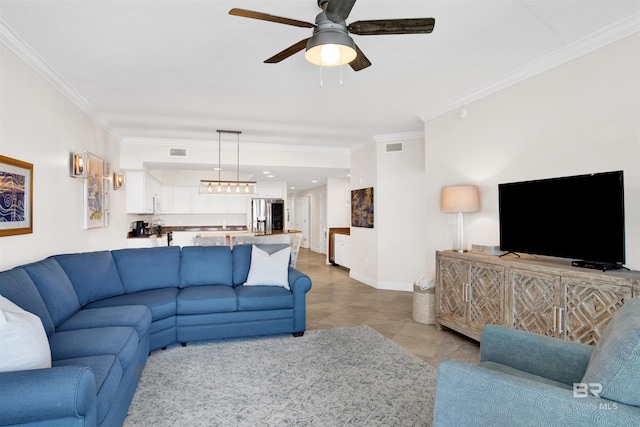 living room with visible vents, crown molding, baseboards, and ceiling fan