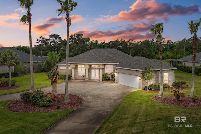 270 Cypress Lake Dr, Gulf Shores, AL 36542 - view of front facade with curved driveway, a garage, a yard, and a shingled roof
