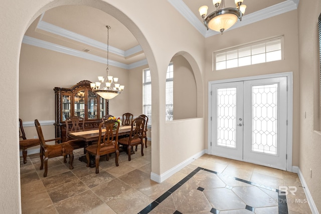 270 Cypress Lake Dr, Gulf Shores, AL 36542 - foyer featuring a chandelier, french doors, ornamental molding, a high ceiling, and arched walkways