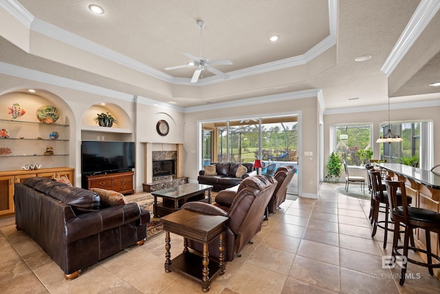 270 Cypress Lake Dr, Gulf Shores, AL 36542 - living area with a tray ceiling, crown molding, built in features, a high end fireplace, and ceiling fan