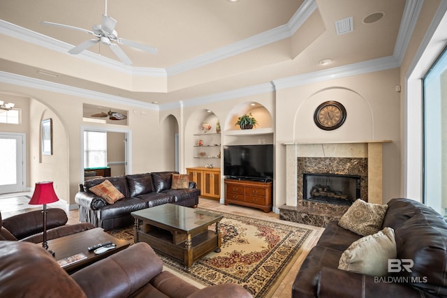 270 Cypress Lake Dr, Gulf Shores, AL 36542 - living area with arched walkways, built in shelves, ceiling fan, ornamental molding, and a fireplace
