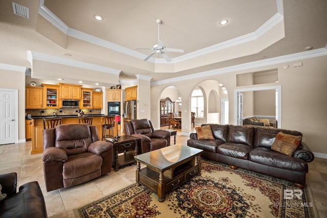 270 Cypress Lake Dr, Gulf Shores, AL 36542 - living room with arched walkways, crown molding, recessed lighting, a ceiling fan, and a tray ceiling