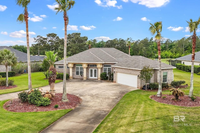 270 Cypress Lake Dr, Gulf Shores, AL 36542 - view of front of property featuring french doors, concrete driveway, an attached garage, and a front lawn