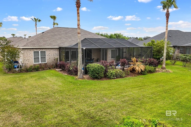 270 Cypress Lake Dr, Gulf Shores, AL 36542 - rear view of house with a lawn, a shingled roof, and glass enclosure