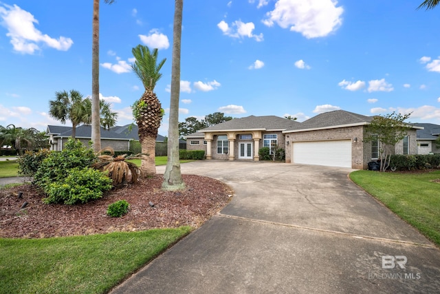 270 Cypress Lake Dr, Gulf Shores, AL 36542 - view of front of property with concrete driveway, an attached garage, and a front yard
