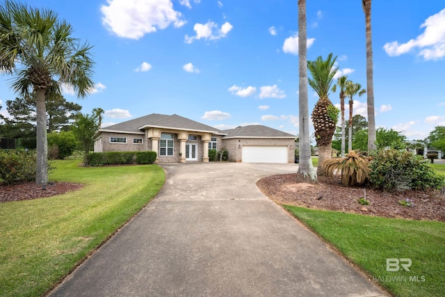 270 Cypress Lake Dr, Gulf Shores, AL 36542 - view of front of property featuring concrete driveway, a front lawn, an attached garage, and stucco siding