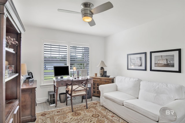 home office featuring ceiling fan and light hardwood / wood-style floors