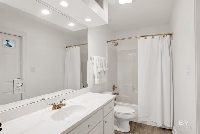 full bathroom featuring vanity, wood-type flooring, toilet, and shower / bath combo with shower curtain