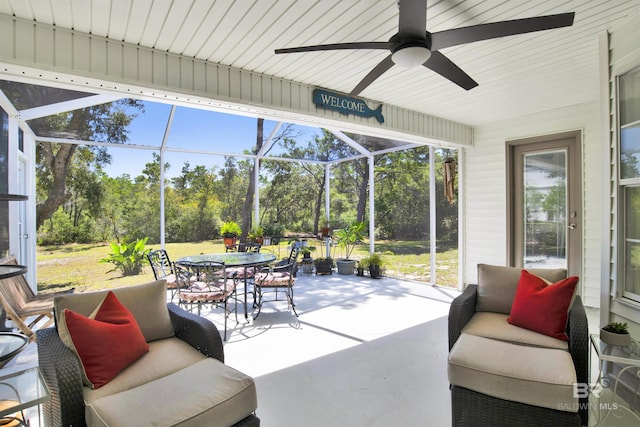 sunroom with a healthy amount of sunlight and ceiling fan