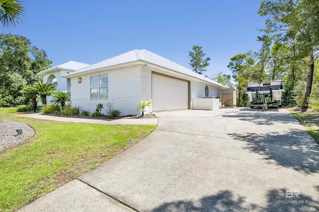 view of side of property with a yard and a garage