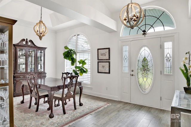 dining space with a chandelier and light hardwood / wood-style floors