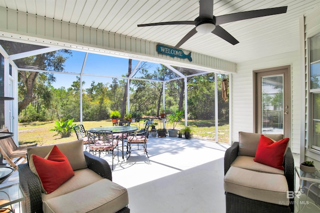 sunroom featuring plenty of natural light and ceiling fan