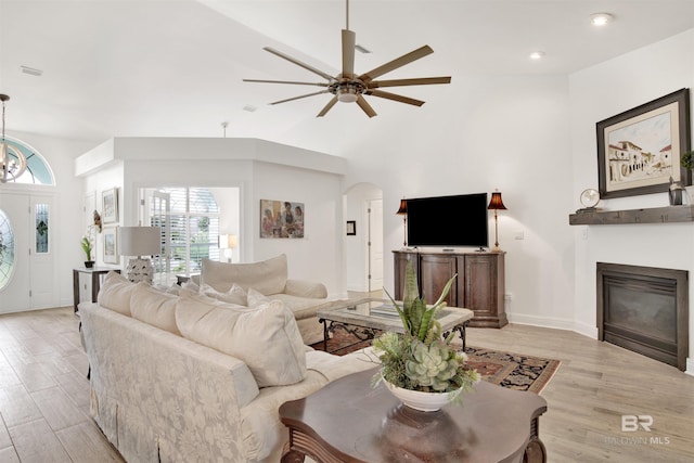 living room with ceiling fan and light hardwood / wood-style floors