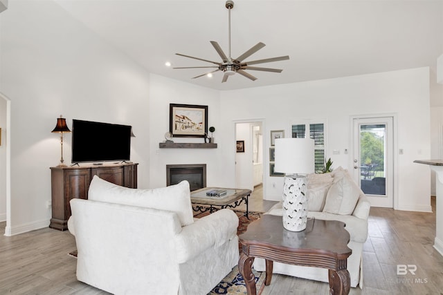 living room featuring ceiling fan and light hardwood / wood-style floors