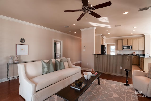 living room featuring crown molding, ceiling fan, light hardwood / wood-style floors, and sink