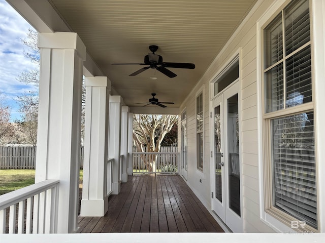 wooden terrace featuring a porch and ceiling fan