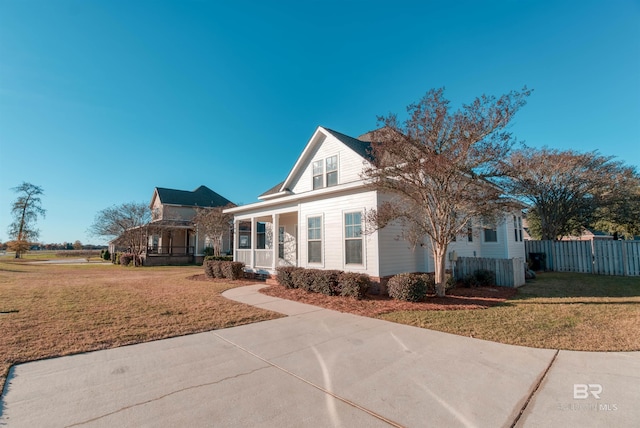 view of front of property with a front yard and covered porch