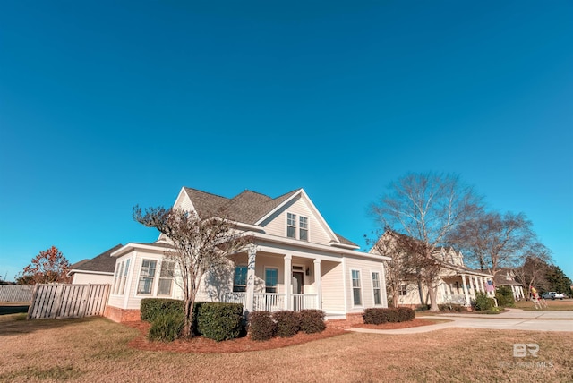 view of front of home with a porch and a front lawn