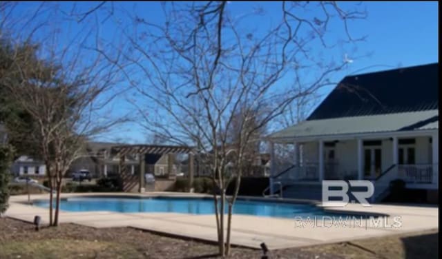 view of swimming pool with a patio area