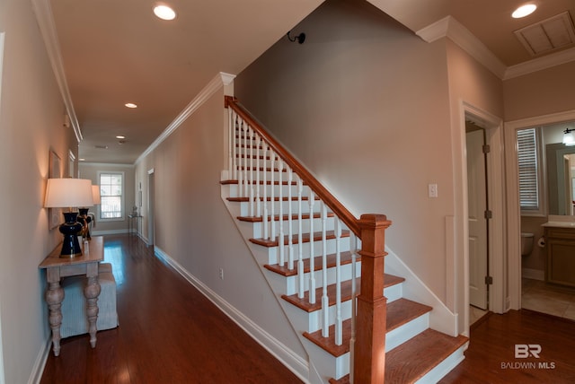 stairway featuring crown molding and hardwood / wood-style floors