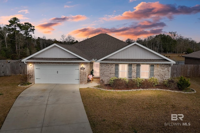 ranch-style home with a garage and a yard