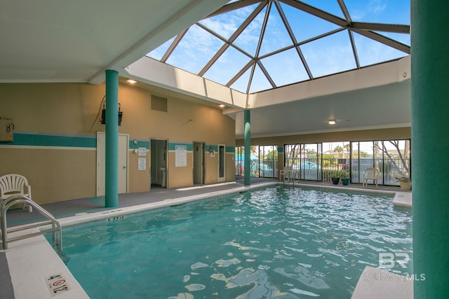 view of pool with glass enclosure