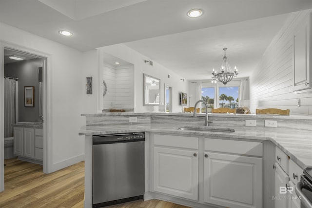 kitchen featuring sink, stainless steel dishwasher, a notable chandelier, and white cabinetry