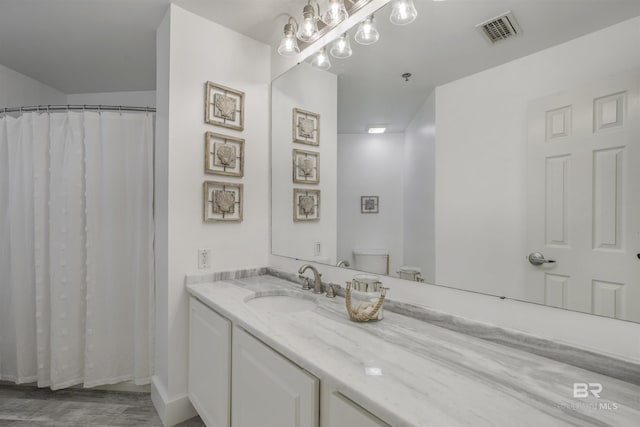 bathroom with toilet and vanity