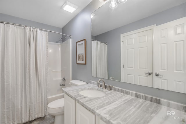 full bathroom featuring toilet, vanity, hardwood / wood-style flooring, and shower / tub combo with curtain