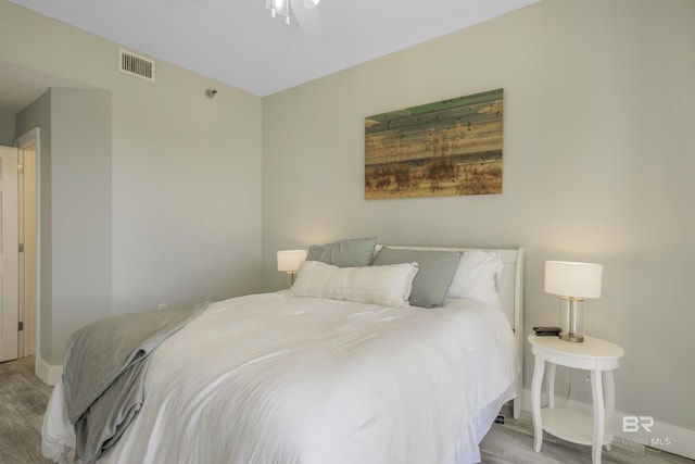 bedroom with ceiling fan and light hardwood / wood-style flooring