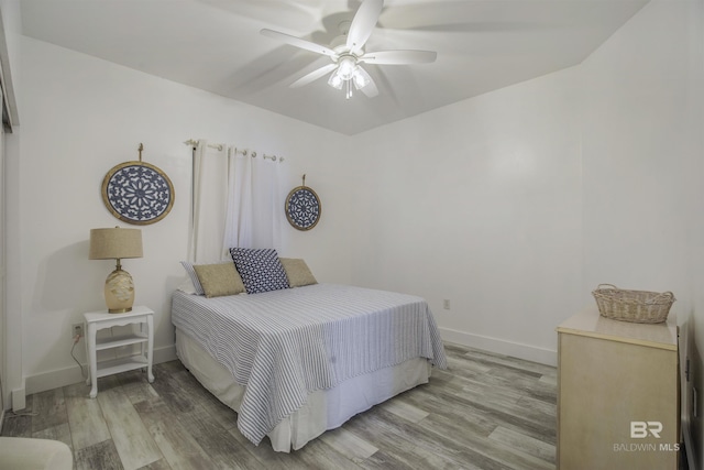 bedroom with ceiling fan and light hardwood / wood-style flooring