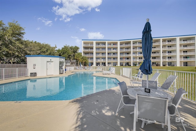 view of swimming pool with a patio