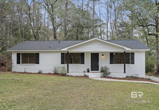 ranch-style home featuring crawl space, brick siding, covered porch, and a front lawn