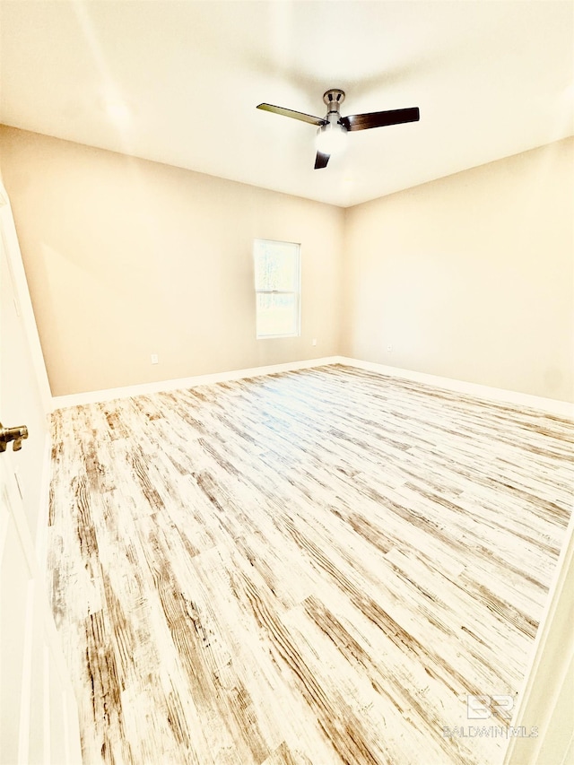 unfurnished room with ceiling fan and light wood-type flooring