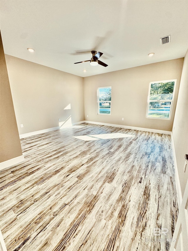 unfurnished room featuring ceiling fan and light wood-type flooring