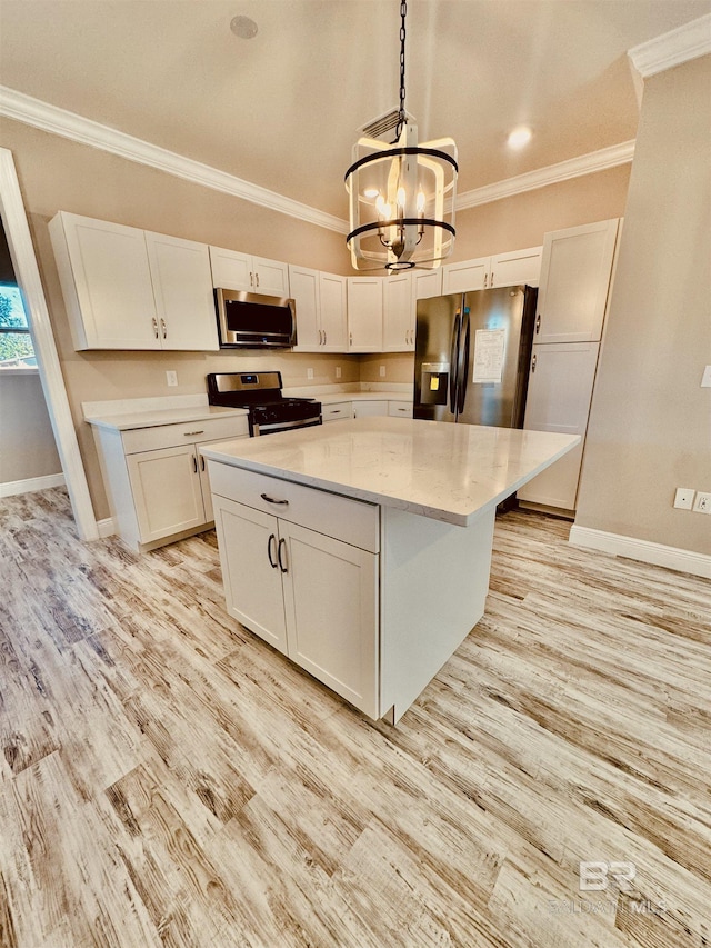 kitchen featuring pendant lighting, light hardwood / wood-style flooring, white cabinetry, stainless steel appliances, and a center island