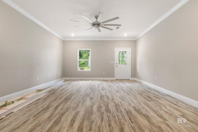 empty room featuring ceiling fan, ornamental molding, and light wood-type flooring