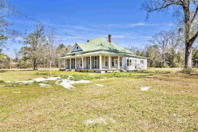 view of front facade featuring crawl space, a chimney, a front lawn, and a porch