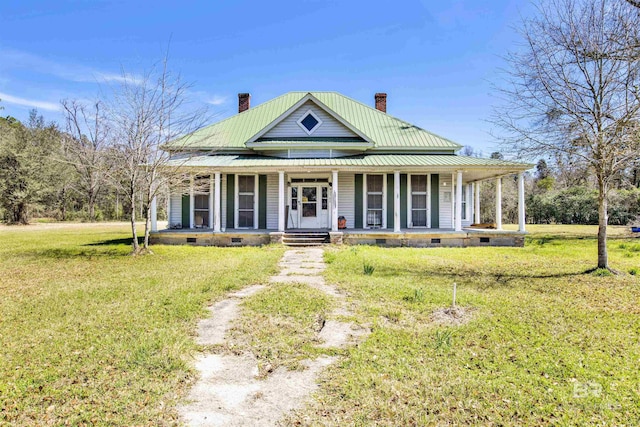 farmhouse inspired home with a chimney, covered porch, a front yard, crawl space, and metal roof